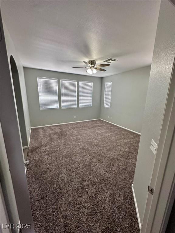 3964 Irvin Ave, Las Vegas, NV 89141 - carpeted spare room with ceiling fan and arched walkways