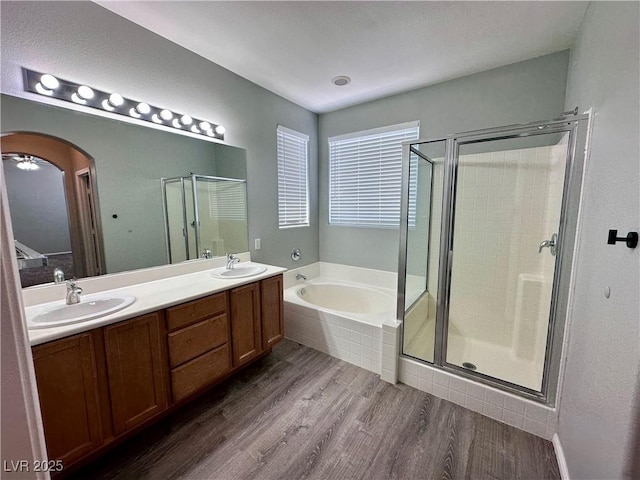 3964 Irvin Ave, Las Vegas, NV 89141 - full bath with a garden tub, wood finished floors, a stall shower, and double vanity