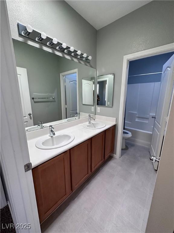 3964 Irvin Ave, Las Vegas, NV 89141 - bathroom featuring double vanity and washtub / shower combination
