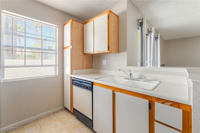 3150 Soft Breezes Dr Unit 1216, Las Vegas, NV 89128 - kitchen with dishwasher, a sink, light countertops, light tile patterned flooring, and baseboards