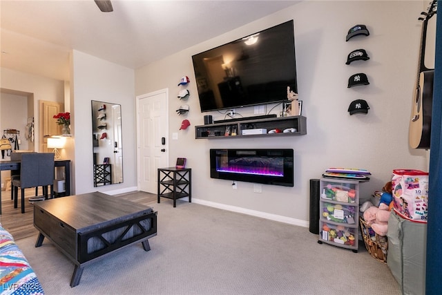 6955 N Durango Dr Unit 2081, Las Vegas, NV 89149 - living room featuring a glass covered fireplace, carpet floors, and baseboards