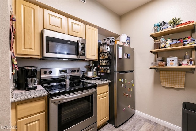 6955 N Durango Dr Unit 2081, Las Vegas, NV 89149 - kitchen with stainless steel appliances, light wood-style flooring, light brown cabinets, baseboards, and open shelves