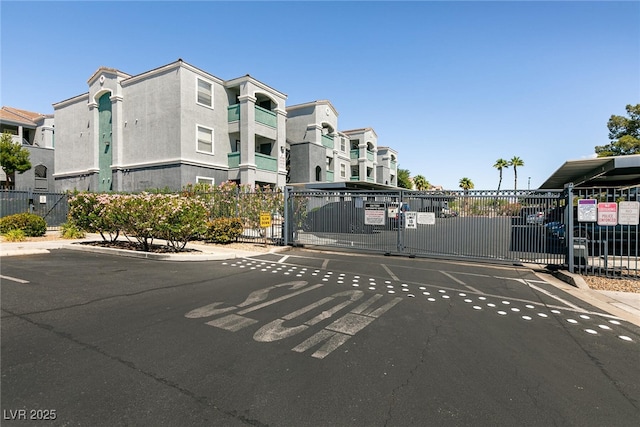 6955 N Durango Dr Unit 2081, Las Vegas, NV 89149 - view of asphalt street featuring a gate, curbs, and a gated entry