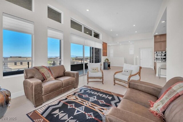 living area with recessed lighting and light tile patterned floors
