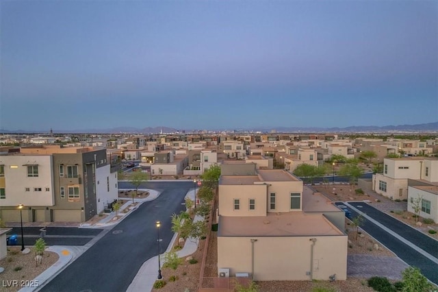 aerial view of residential area featuring a mountainous background