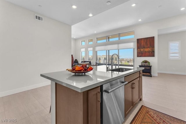 kitchen featuring a sink, stainless steel dishwasher, healthy amount of natural light, baseboards, and recessed lighting