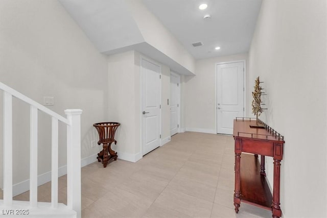 hall with recessed lighting, baseboards, stairway, and light tile patterned floors