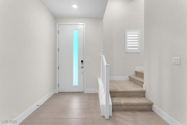 entrance foyer featuring stairway, baseboards, and tile patterned flooring