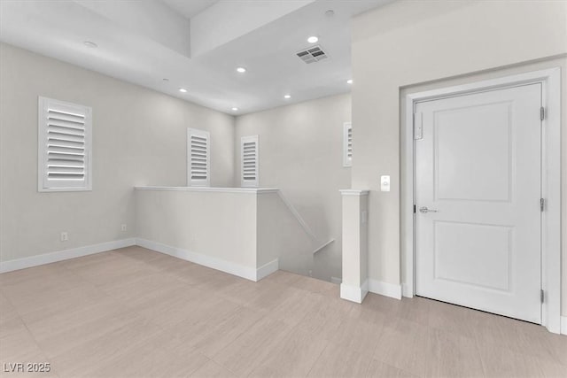 unfurnished room with recessed lighting and baseboards