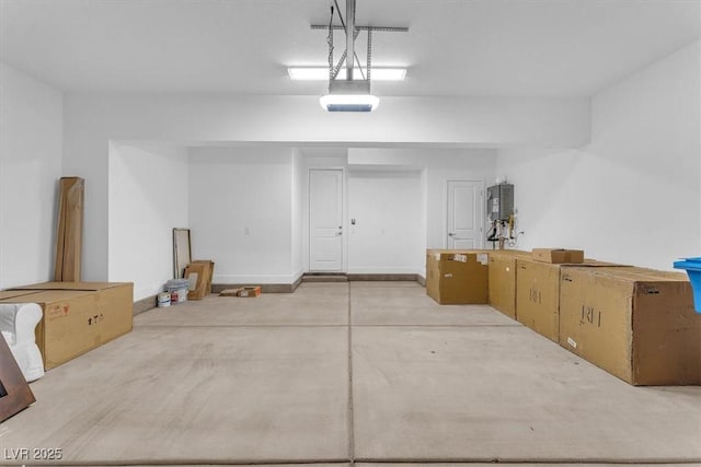 garage featuring water heater and a garage door opener