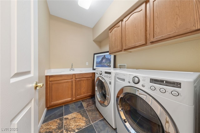 8547 Benidorm Ave, Las Vegas, NV 89178 - laundry room featuring washer and clothes dryer, cabinet space, dark stone finish flooring, and baseboards