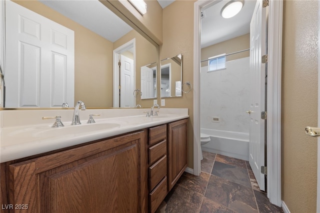 8547 Benidorm Ave, Las Vegas, NV 89178 - bathroom with toilet, stone tile floors, double vanity, bathtub / shower combination, and baseboards