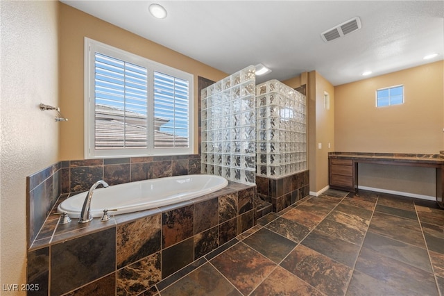 8547 Benidorm Ave, Las Vegas, NV 89178 - full bathroom featuring a bath, a walk in shower, stone tile floors, recessed lighting, and baseboards