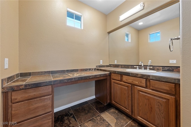 8547 Benidorm Ave, Las Vegas, NV 89178 - bathroom with vanity, plenty of natural light, and stone finish flooring
