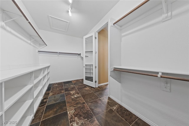 8547 Benidorm Ave, Las Vegas, NV 89178 - spacious closet with attic access and dark stone finish flooring