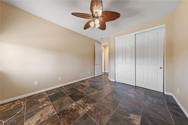 8547 Benidorm Ave, Las Vegas, NV 89178 - unfurnished bedroom with baseboards, stone tile floors, a closet, and ceiling fan