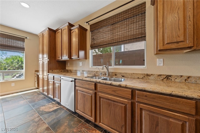 8547 Benidorm Ave, Las Vegas, NV 89178 - kitchen featuring stainless steel dishwasher, a sink, light stone countertops, brown cabinetry, and recessed lighting