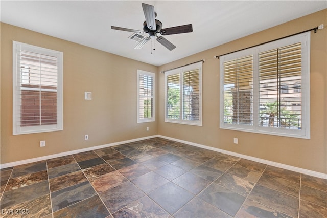 8547 Benidorm Ave, Las Vegas, NV 89178 - unfurnished room featuring baseboards, a ceiling fan, and stone finish floors
