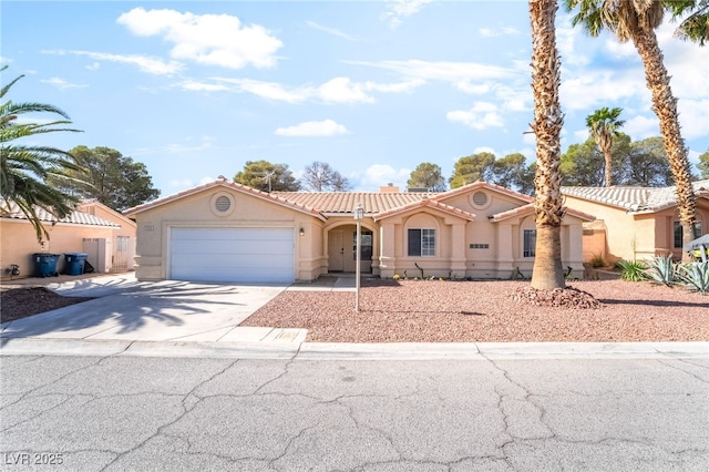 3145 Tarpon Dr, Las Vegas, NV 89120 - mediterranean / spanish home with stucco siding, an attached garage, driveway, and a tiled roof