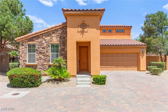 1252 Casa Palermo Cir, Henderson, NV 89011 - mediterranean / spanish-style home featuring a tile roof, stucco siding, decorative driveway, stone siding, and fence