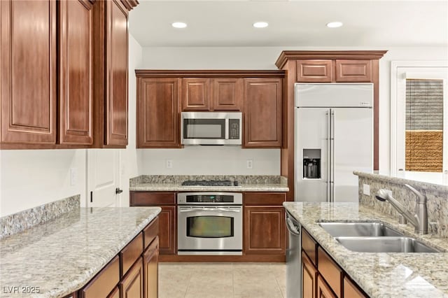 1252 Casa Palermo Cir, Henderson, NV 89011 - kitchen featuring stainless steel appliances, a sink, light stone countertops, light tile patterned floors, and recessed lighting