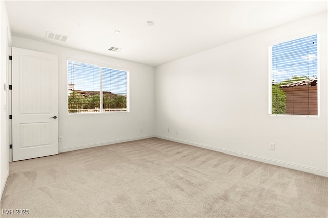 1252 Casa Palermo Cir, Henderson, NV 89011 - spare room featuring light colored carpet, plenty of natural light, and baseboards