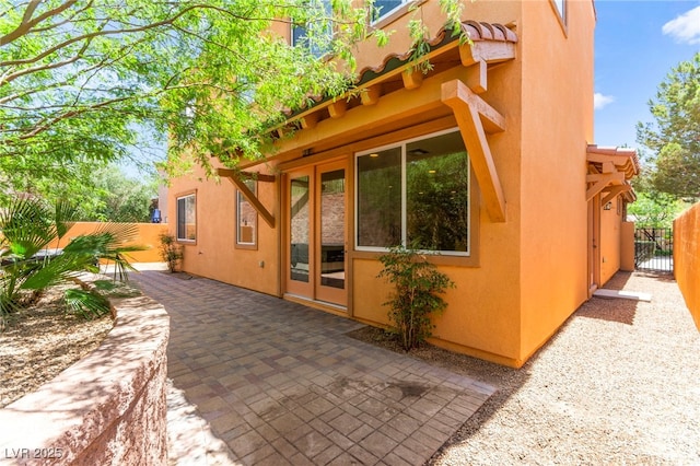 1252 Casa Palermo Cir, Henderson, NV 89011 - view of side of property featuring stucco siding, a patio area, and fence