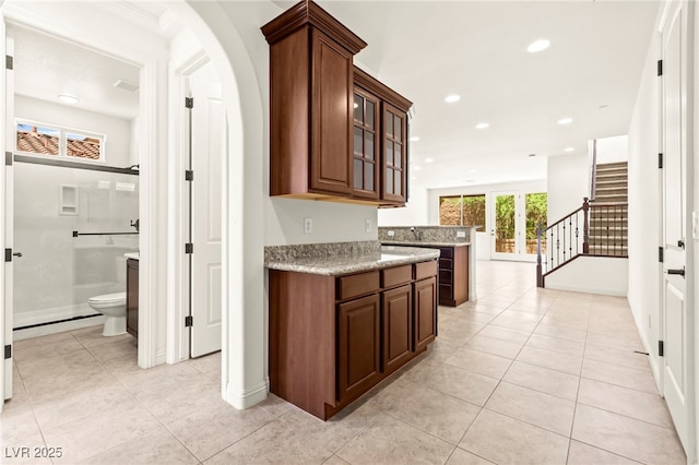 1252 Casa Palermo Cir, Henderson, NV 89011 - bar featuring stairway, light tile patterned floors, recessed lighting, and baseboards
