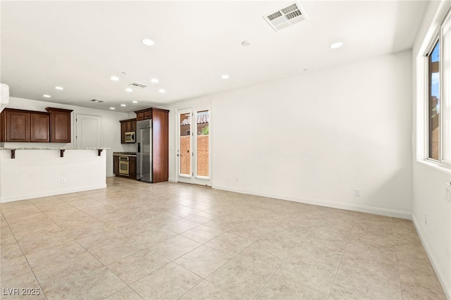 1252 Casa Palermo Cir, Henderson, NV 89011 - unfurnished living room with recessed lighting, healthy amount of natural light, light tile patterned floors, and baseboards