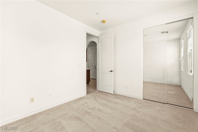 1252 Casa Palermo Cir, Henderson, NV 89011 - unfurnished bedroom with arched walkways, a closet, carpet floors, and baseboards