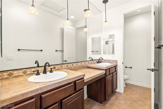 1252 Casa Palermo Cir, Henderson, NV 89011 - bathroom with toilet, double vanity, tile patterned floors, and decorative backsplash