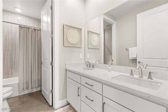 bathroom with toilet, double vanity, shower / bath combo, tile patterned flooring, and baseboards