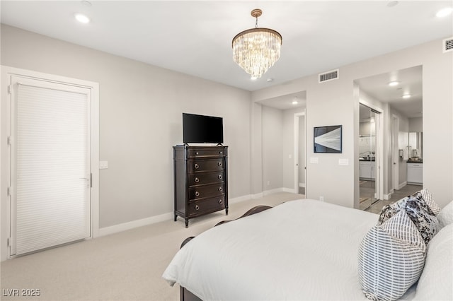 bedroom with a chandelier, baseboards, recessed lighting, light colored carpet, and ensuite bath