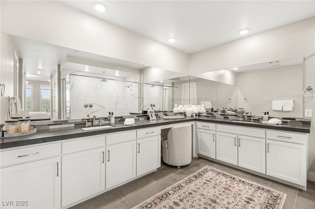 full bath with a stall shower, two vanities, tile patterned flooring, and recessed lighting