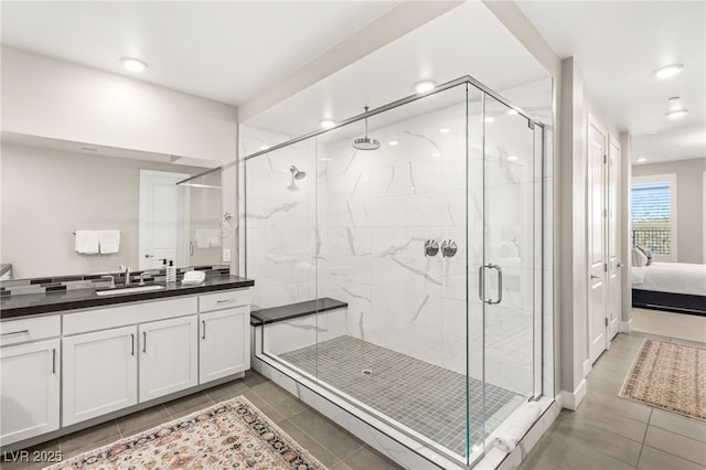 full bath with tile patterned flooring, a shower stall, vanity, ensuite bathroom, and recessed lighting