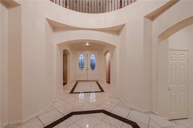 386 Wiseton Ave, Las Vegas, NV 89183 - entryway featuring inlaid floor details, arched walkways, baseboards, and a high ceiling