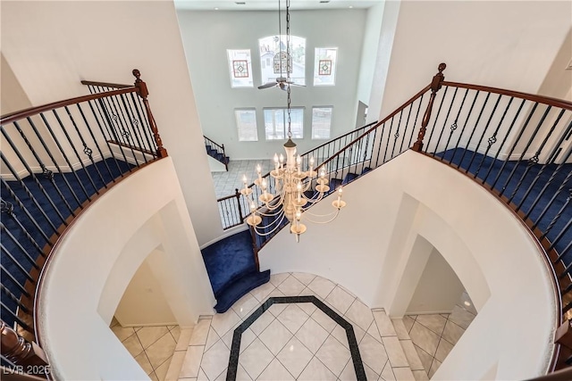 386 Wiseton Ave, Las Vegas, NV 89183 - stairway with a towering ceiling, tile patterned flooring, a chandelier, and a ceiling fan