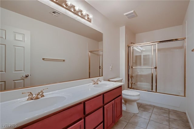 386 Wiseton Ave, Las Vegas, NV 89183 - full bathroom featuring tile patterned flooring, toilet, double vanity, and bath / shower combo with glass door