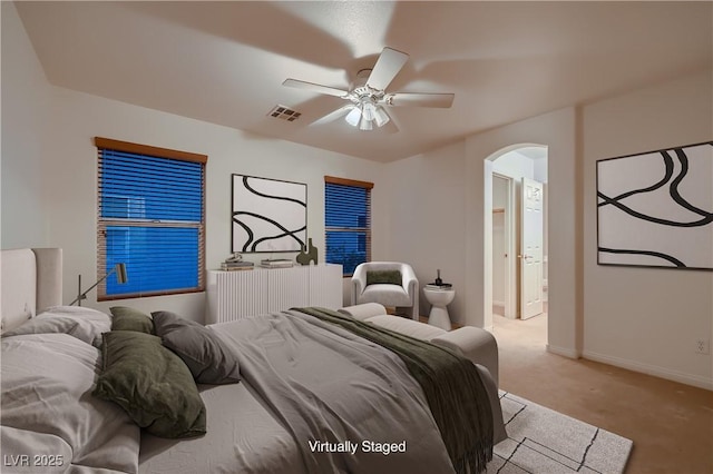 386 Wiseton Ave, Las Vegas, NV 89183 - carpeted bedroom with arched walkways, baseboards, ceiling fan, and connected bathroom