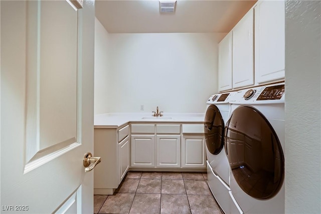 386 Wiseton Ave, Las Vegas, NV 89183 - clothes washing area with cabinet space, washer and clothes dryer, and light tile patterned flooring