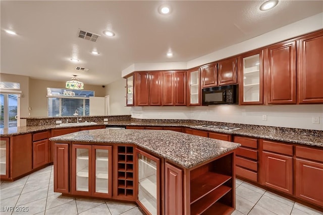 386 Wiseton Ave, Las Vegas, NV 89183 - kitchen with black microwave, a sink, a peninsula, stainless steel gas stovetop, and light tile patterned floors