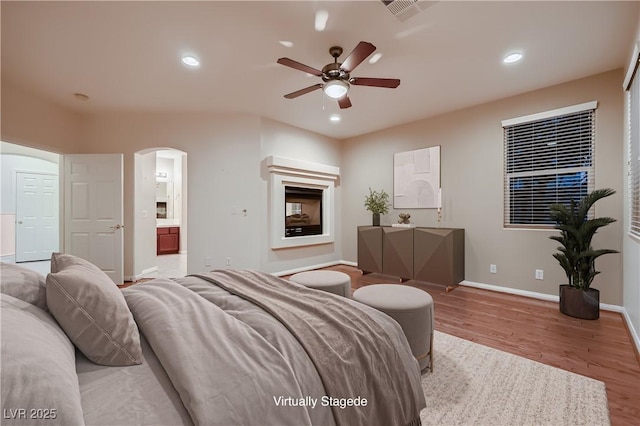 386 Wiseton Ave, Las Vegas, NV 89183 - living room featuring a ceiling fan, arched walkways, baseboards, wood finished floors, and recessed lighting