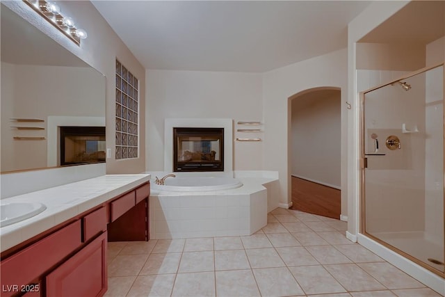 386 Wiseton Ave, Las Vegas, NV 89183 - full bath with a multi sided fireplace, a shower stall, and a garden tub