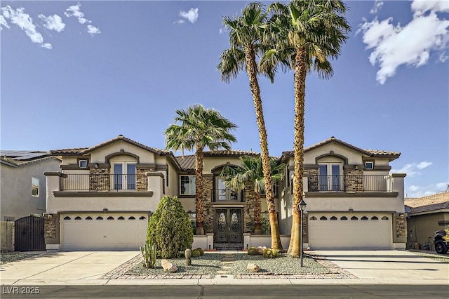 386 Wiseton Ave, Las Vegas, NV 89183 - mediterranean / spanish house featuring a balcony, an attached garage, and driveway