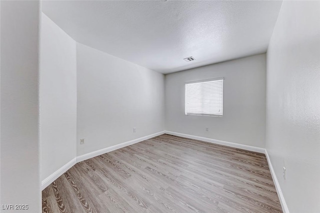 11028 Meadow Leaf Ave, Las Vegas, NV 89144 - empty room with wood finished floors, baseboards, and a textured ceiling