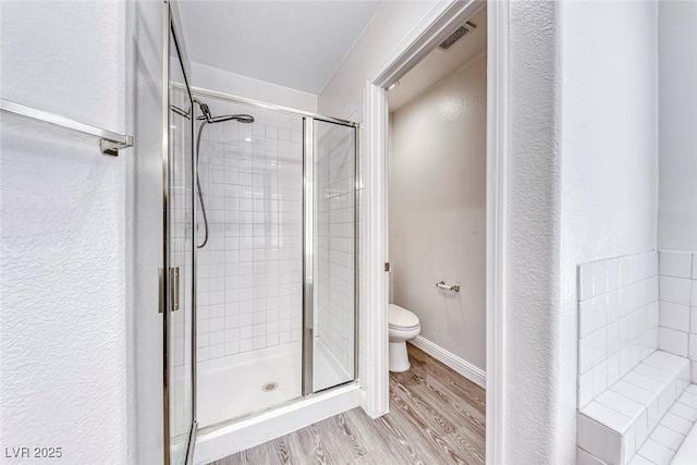 11028 Meadow Leaf Ave, Las Vegas, NV 89144 - full bath with a stall shower, toilet, and wood finished floors