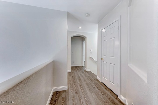 11028 Meadow Leaf Ave, Las Vegas, NV 89144 - hall featuring arched walkways, wood finished floors, and baseboards