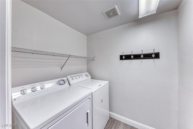 11028 Meadow Leaf Ave, Las Vegas, NV 89144 - laundry area featuring washer and clothes dryer, baseboards, and wood finished floors