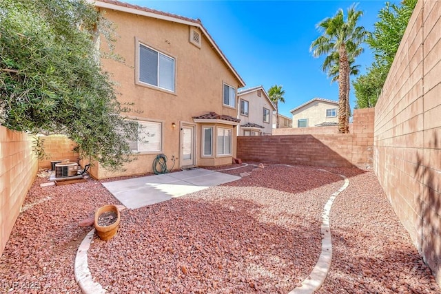11028 Meadow Leaf Ave, Las Vegas, NV 89144 - rear view of house with stucco siding, a fenced backyard, cooling unit, and a patio area