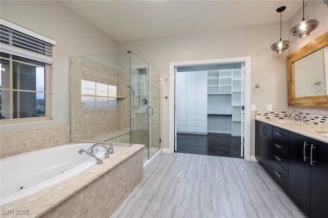 2900 Valvent Ct, Henderson, NV 89044 - full bathroom with a shower stall, a spacious closet, vanity, a tub with jets, and tasteful backsplash